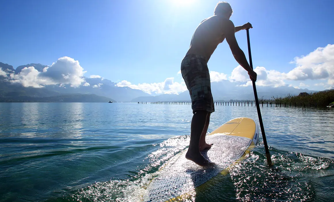 Homme en train de faire du paddle sur le lac d'annecy